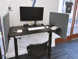 A desk at DropBy Office with a rentable Mac Mini